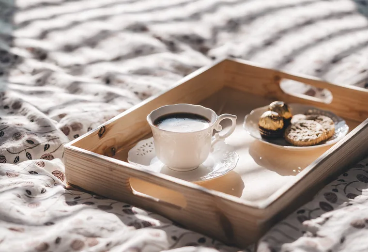 A coffee tray with a cup and snacks