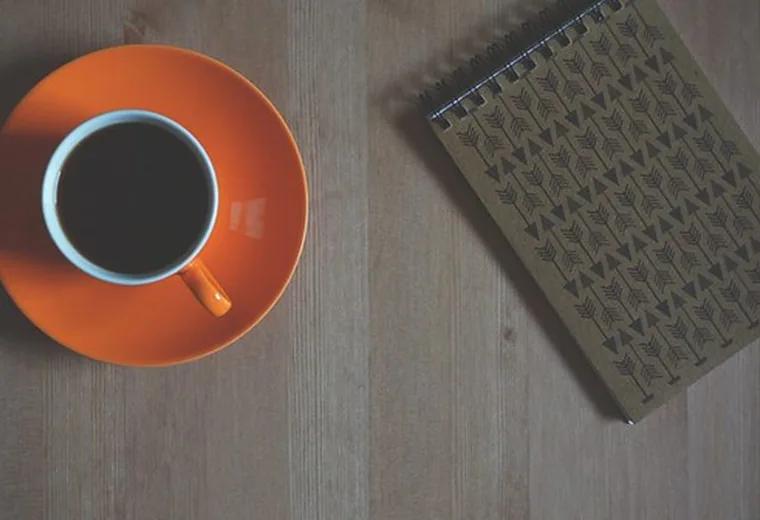 An espresso on an orange saucer