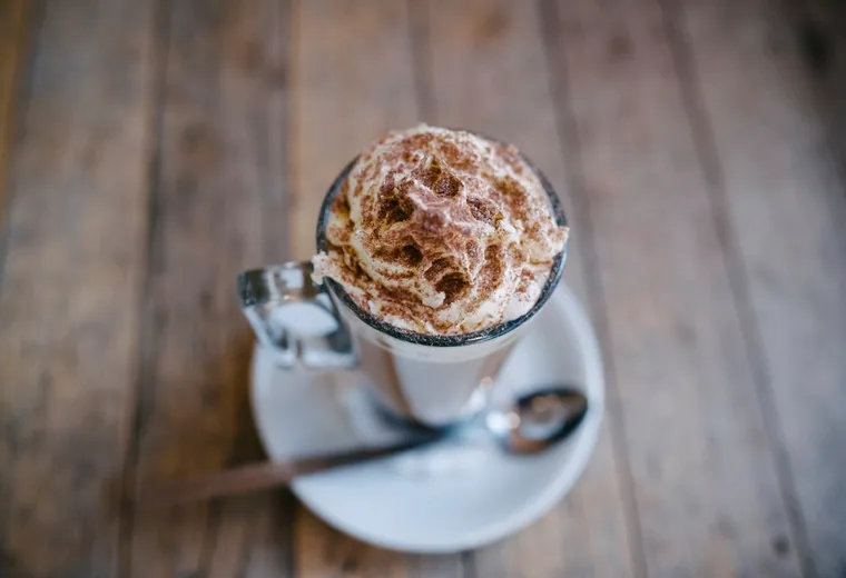 Iced coffee with foam in a glass