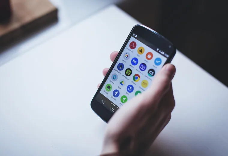 Ordering on a phone A hand holding a smartphone with apps