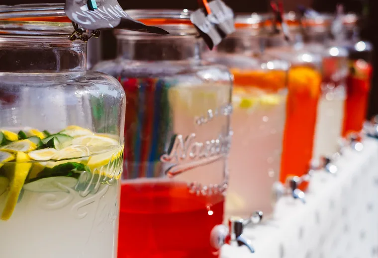 A row of colorful fruit drinks